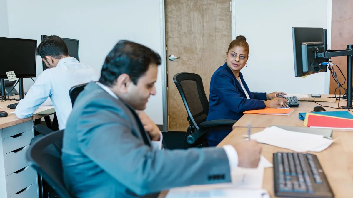 Digital agency team working together at desks in a modern office