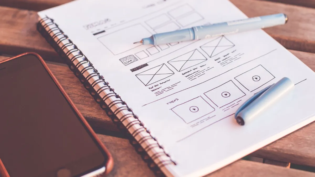 UX wireframe sketches for a mobile app and website